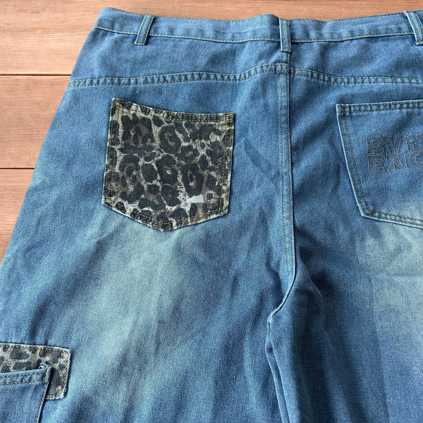 Vintage style baggy wide leg skater fit jorts shorts with leopard print in mid blue.