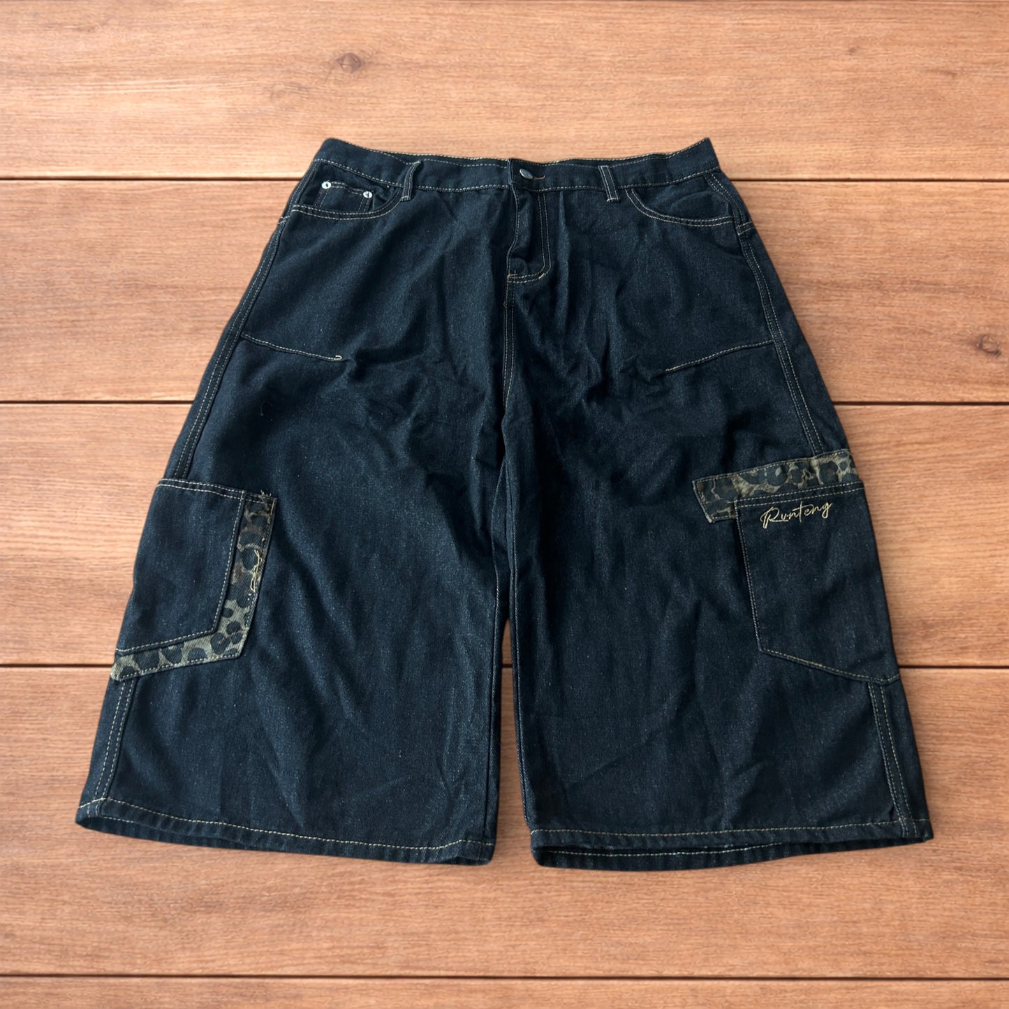 Vintage style baggy wide skater jorts shorts with leopard print in black.