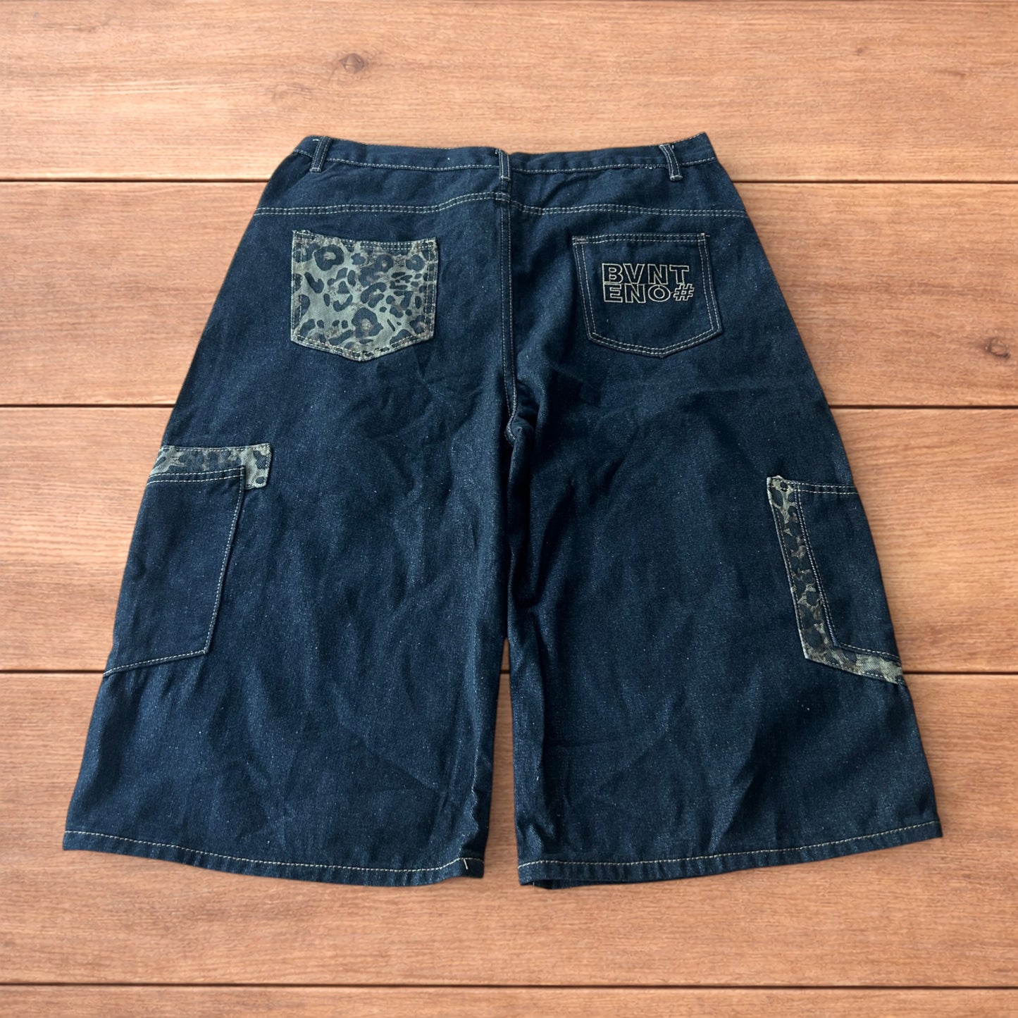 Vintage style baggy wide skater jorts shorts with leopard print in black.
