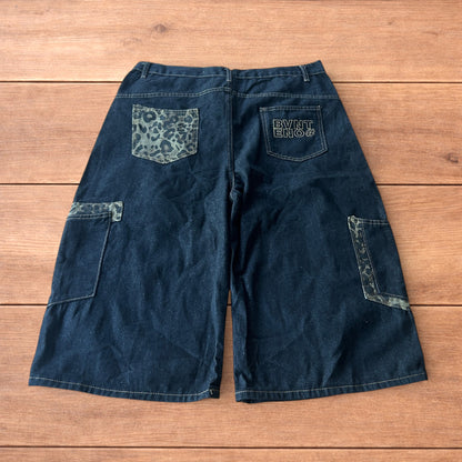 Vintage style baggy wide skater jorts shorts with leopard print in black.