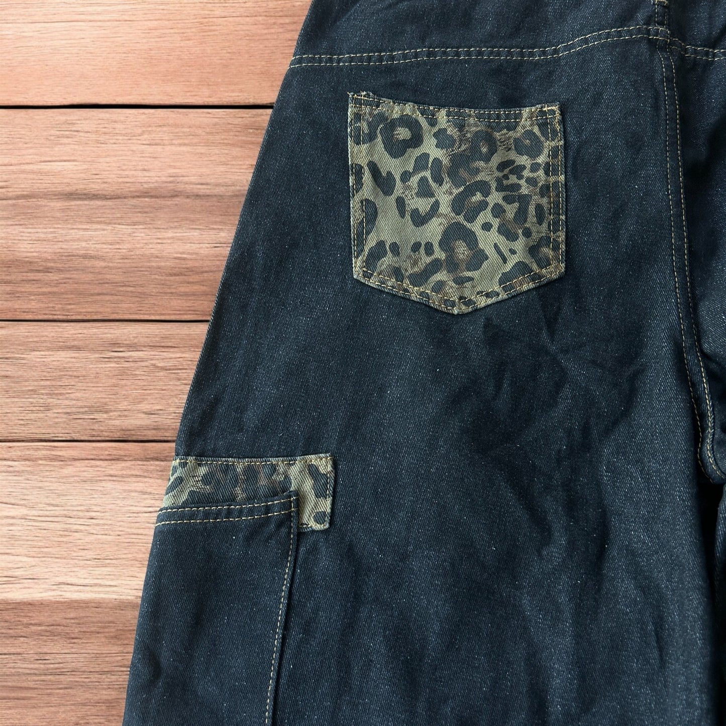 Vintage style baggy wide skater jorts shorts with leopard print in black.