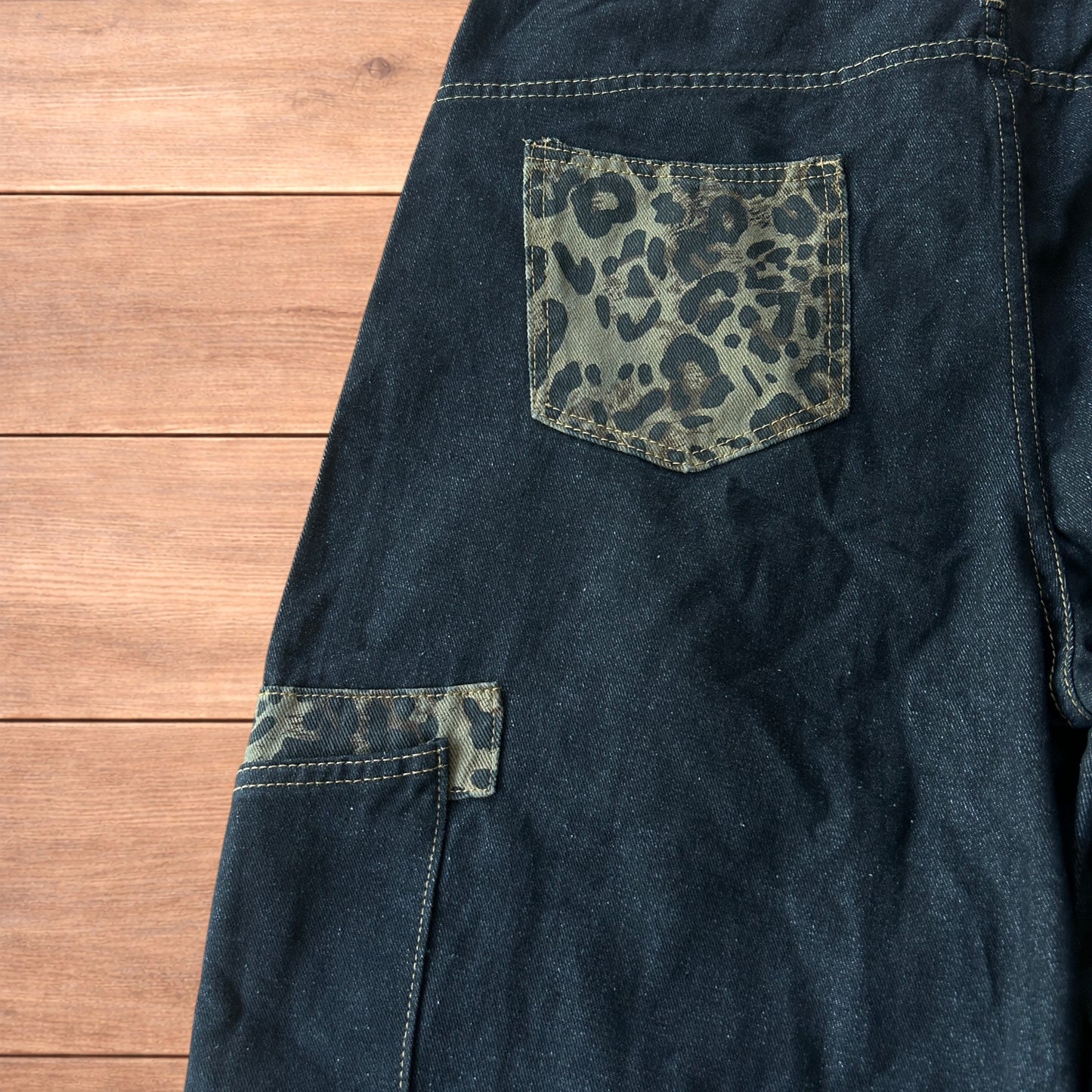 Vintage style baggy wide skater jorts shorts with leopard print in black.