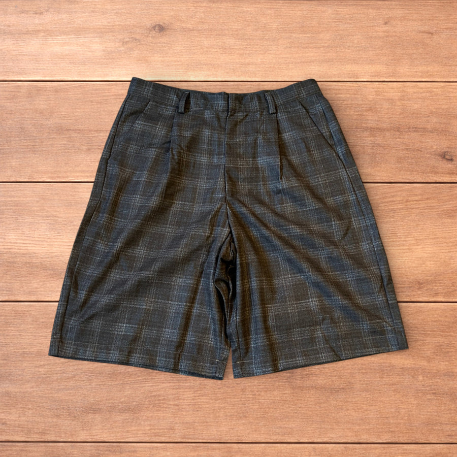 Vintage style baggy wide leg checkered tailored shorts jorts in brown laid flat on wooden surface, front and back views