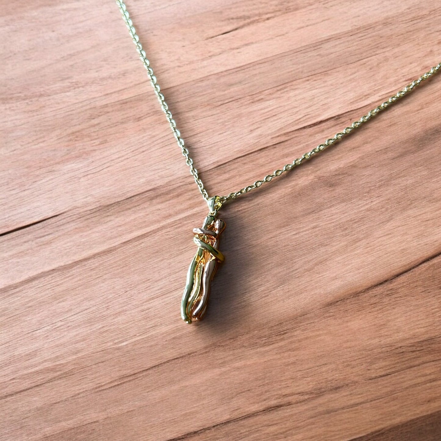 Lovely stainless steel necklace of couple figure silhouettes dancing in gold/rose gold.