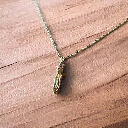 Lovely stainless steel necklace of couple figure silhouettes dancing in gold/rose gold.