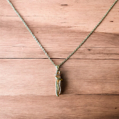 Lovely stainless steel necklace of couple figure silhouettes dancing in gold/rose gold.