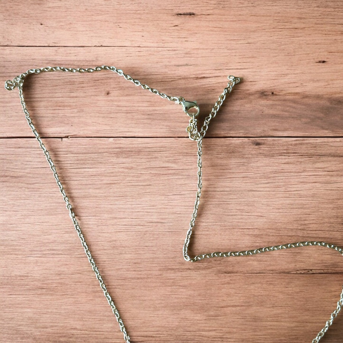 Lovely stainless steel necklace of couple figure silhouettes dancing in gold/rose gold.