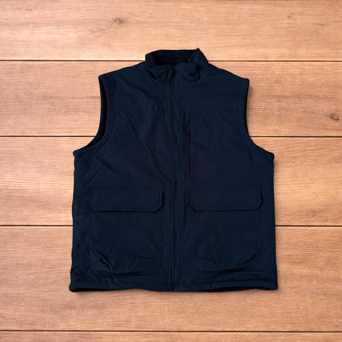 Reversible black utility gilet with high neck, full zip and pockets on both fleece and nylon sides.