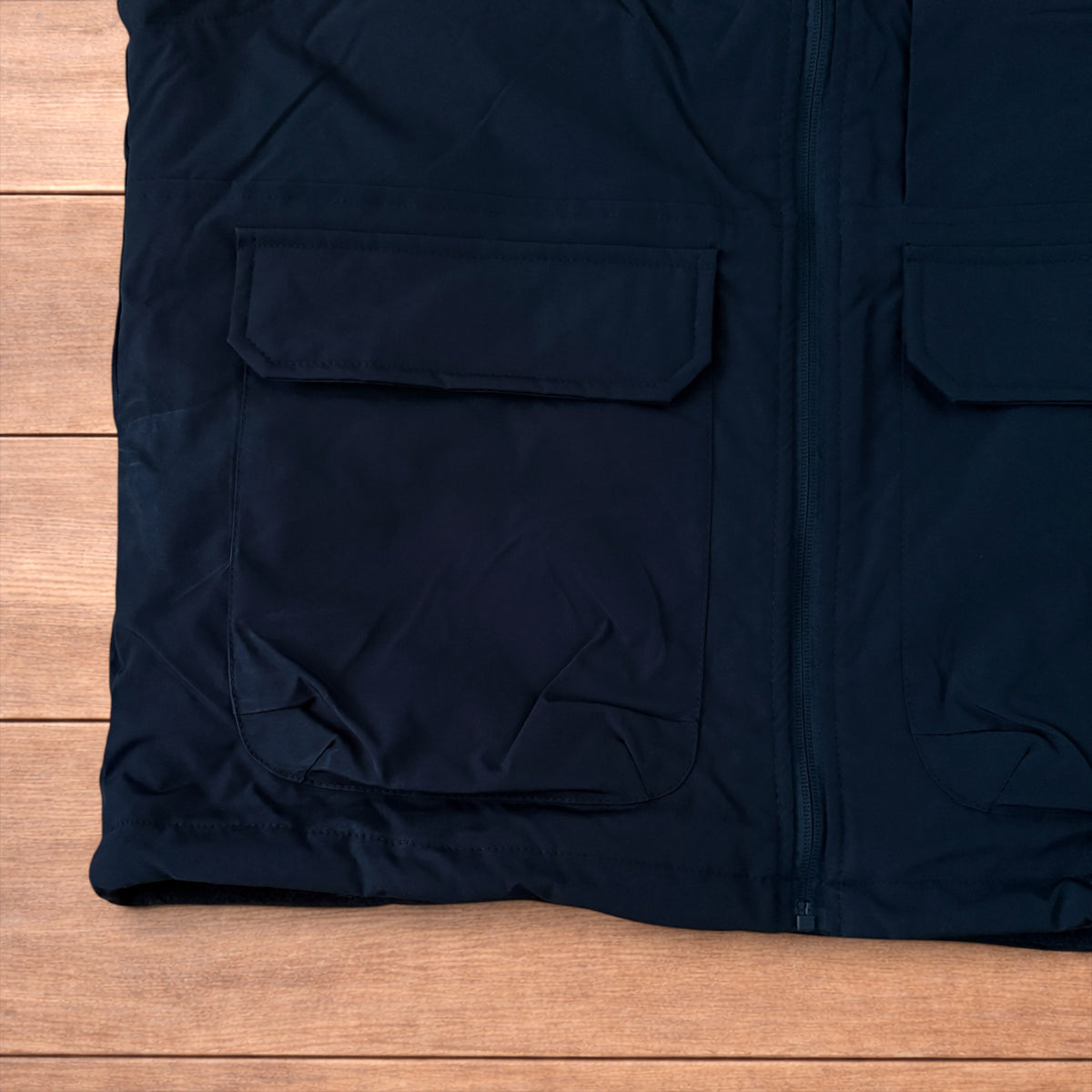 Reversible black utility gilet with high neck, full zip and pockets on both fleece and nylon sides.
