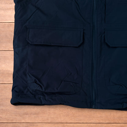 Reversible black utility gilet with high neck, full zip and pockets on both fleece and nylon sides.