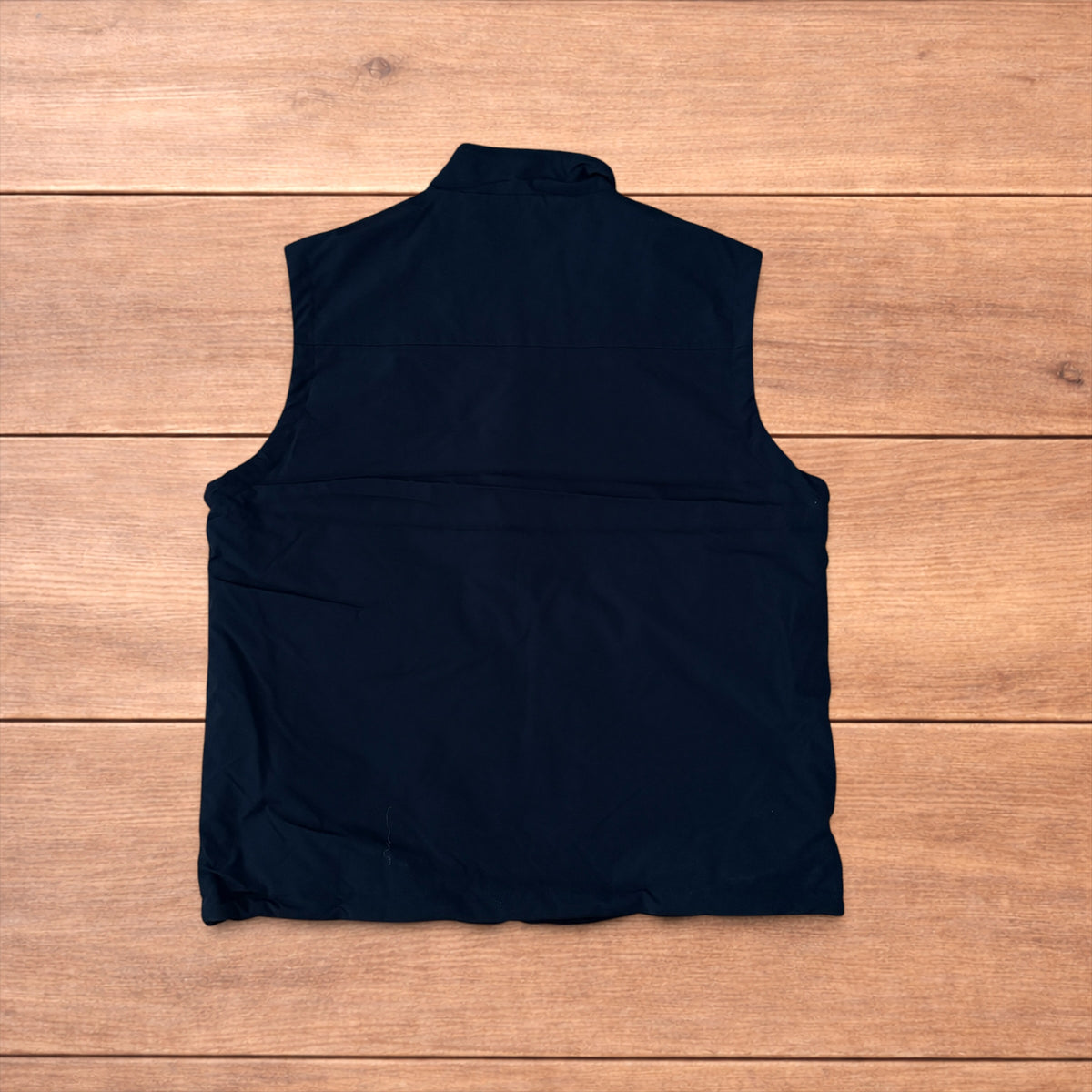 Reversible black utility gilet with high neck, full zip and pockets on both fleece and nylon sides.