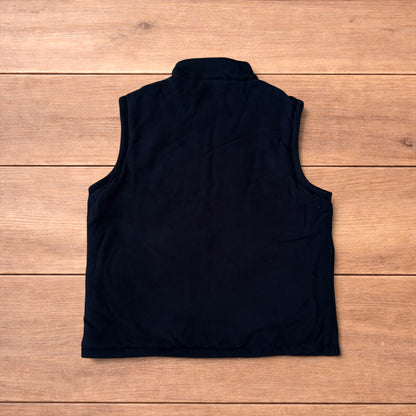 Reversible black utility gilet with high neck, full zip and pockets on both fleece and nylon sides.