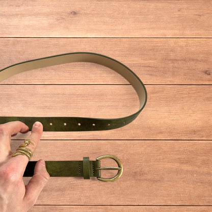 Vintage style faux leather boho cowboy belt in olive green with gold trim.