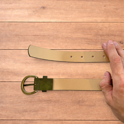 Vintage style faux leather boho cowboy belt in olive green with gold trim.