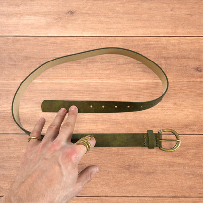 Vintage style faux leather boho cowboy belt in olive green with gold trim.