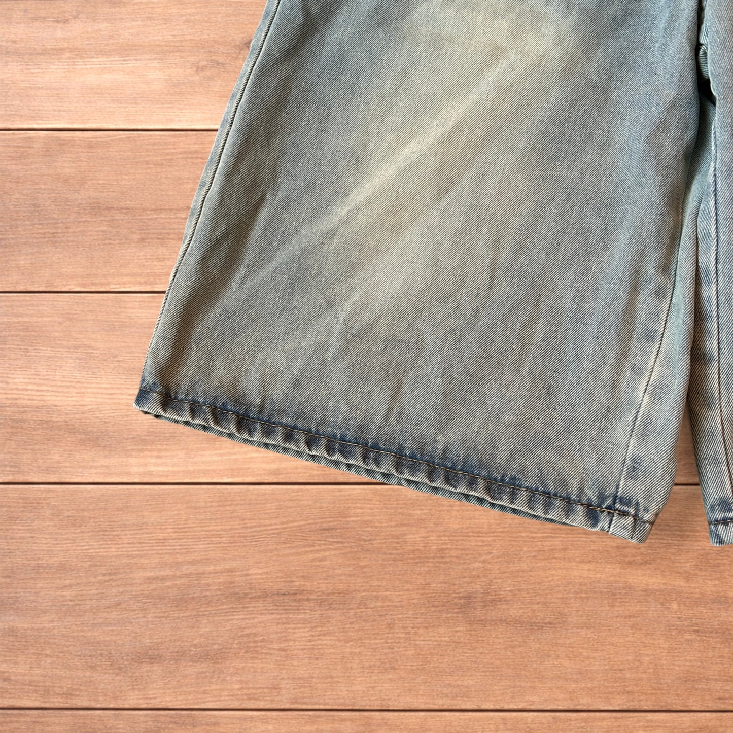 Vintage style baggy wide leg denim shorts jorts with fade in light blue.