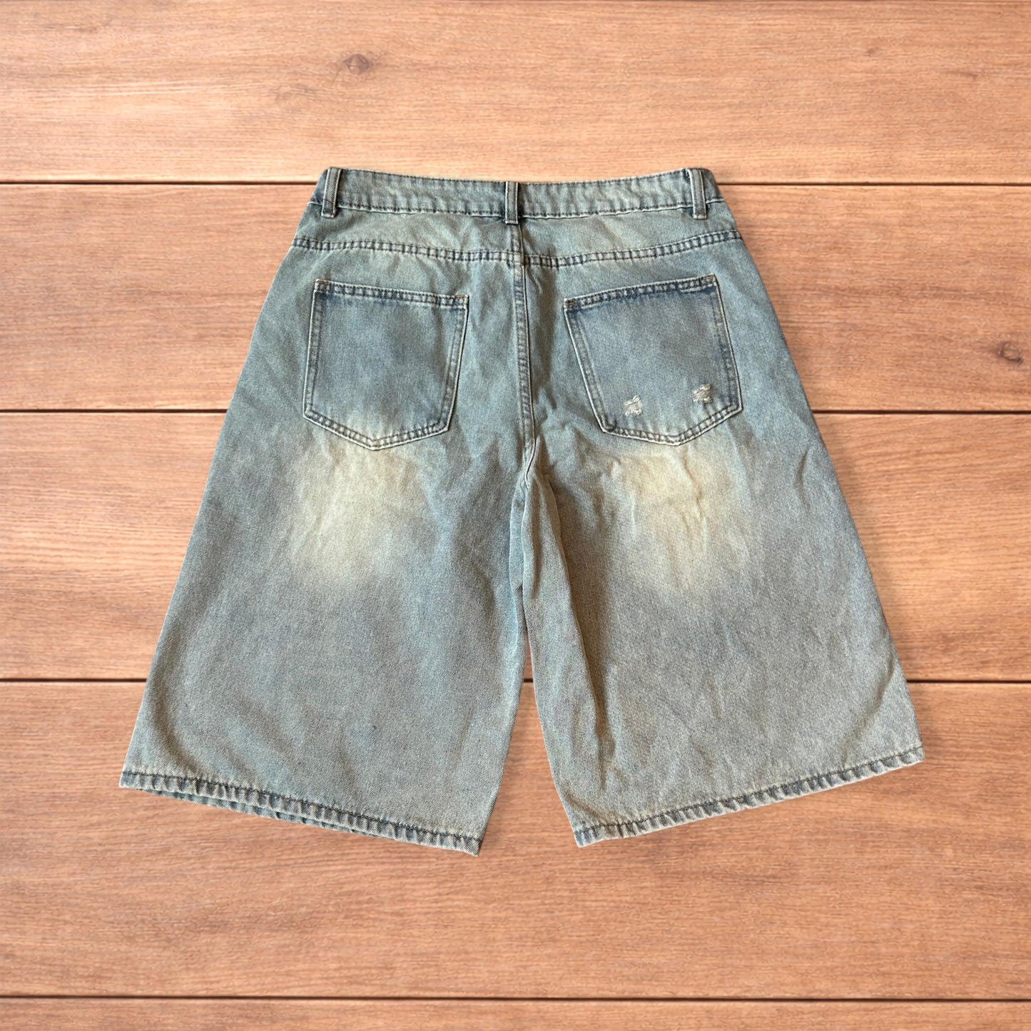 Vintage style baggy wide leg denim shorts jorts with fade in light blue.