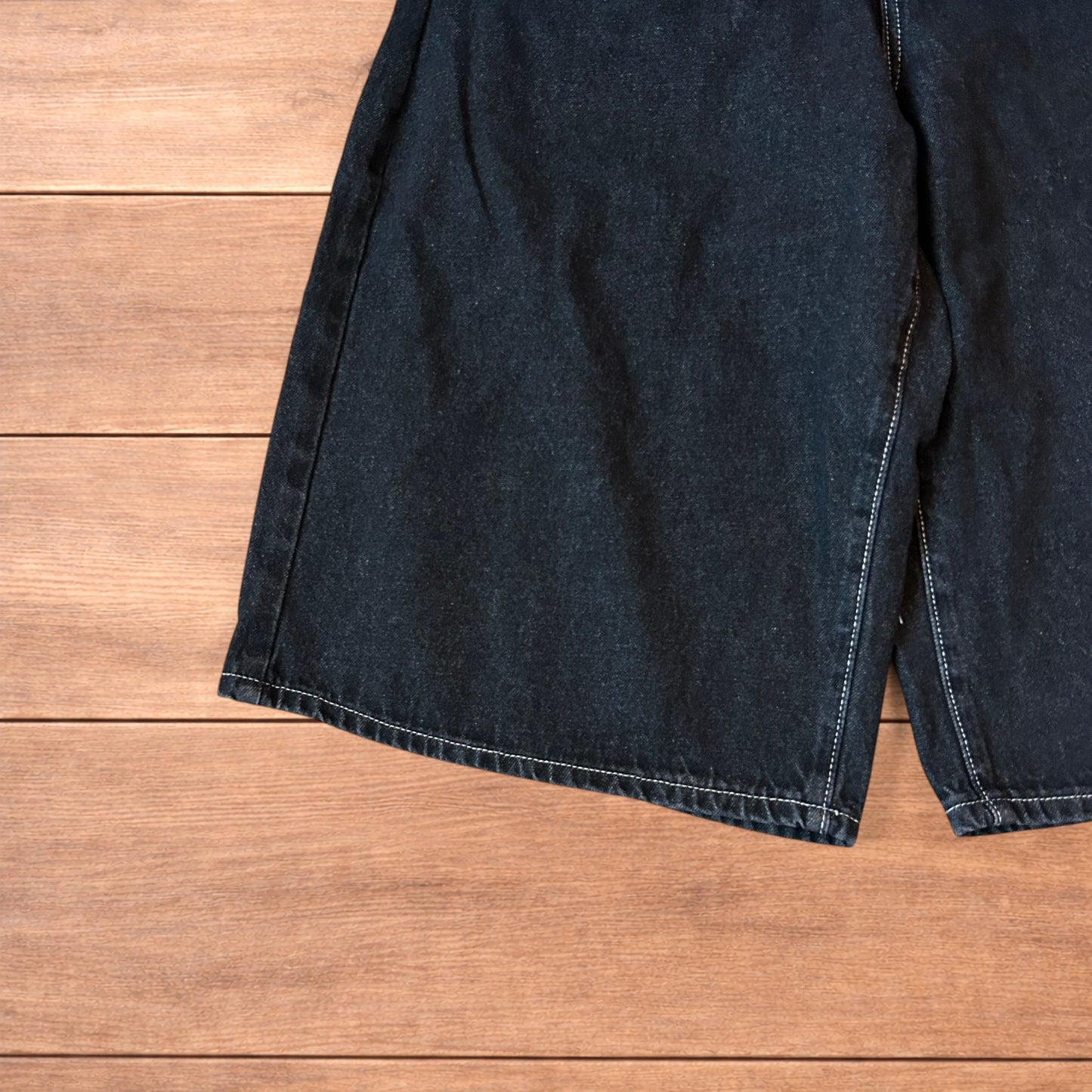 Vintage style baggy wide leg denim shorts jorts with buckles in black.