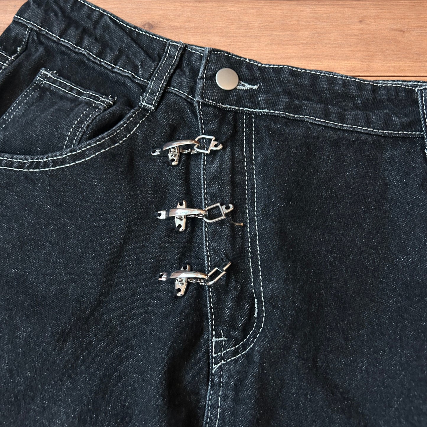 Vintage style baggy wide leg denim shorts jorts with buckles in black.