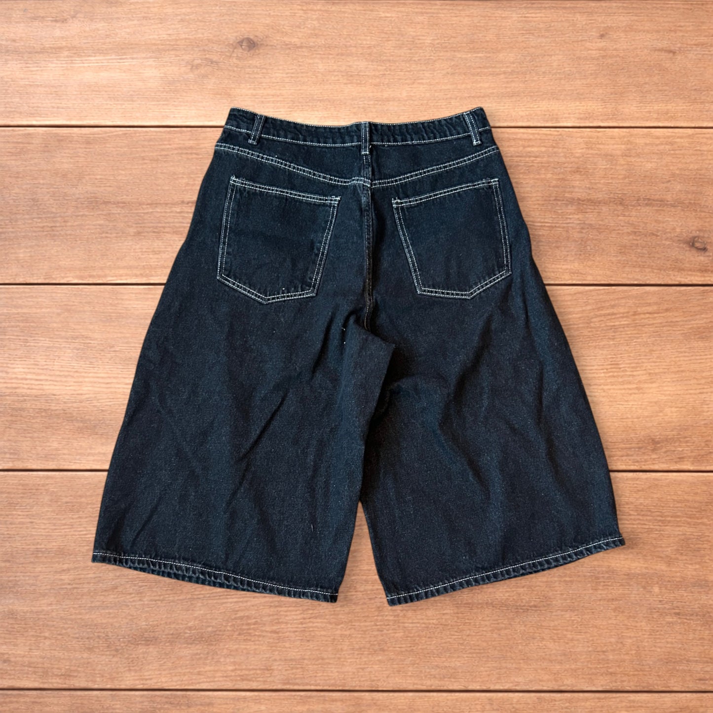 Vintage style baggy wide leg denim shorts jorts with buckles in black.