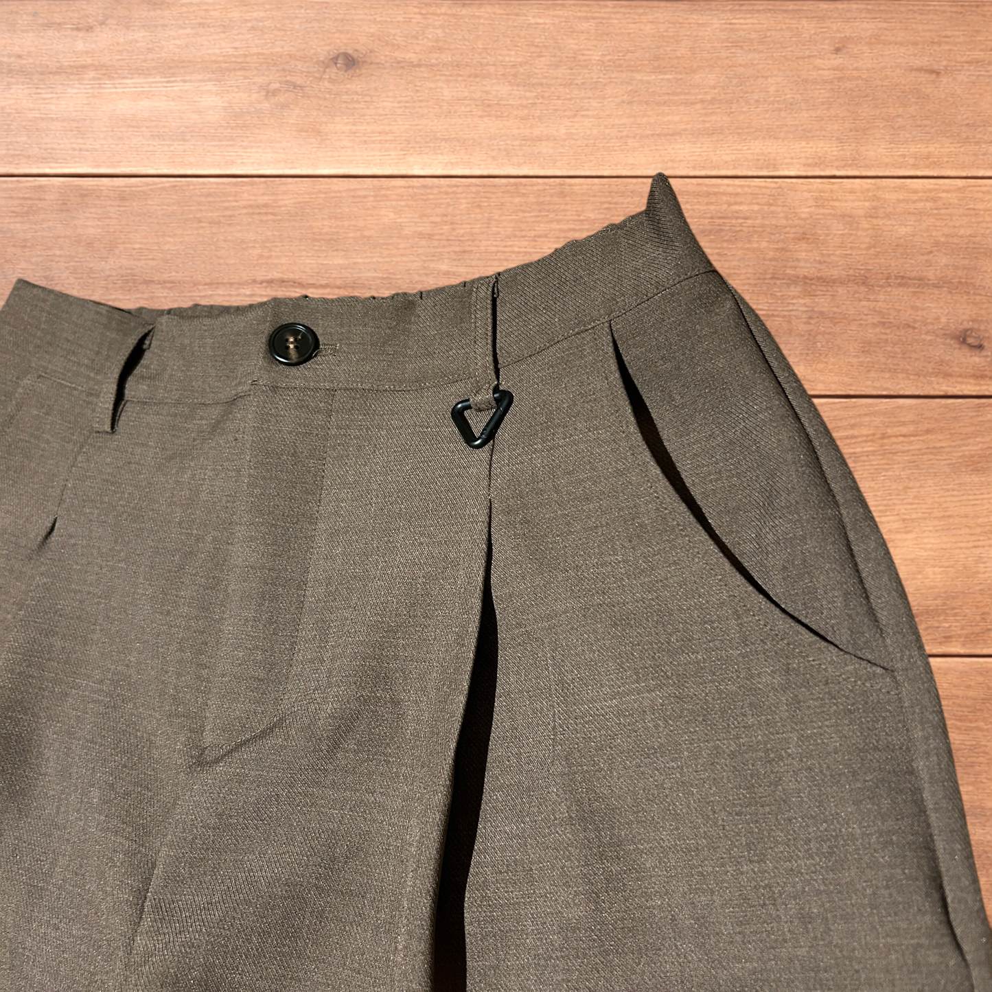 Vintage style baggy wide leg tailored brown trousers laid flat showing front, back, waistband, and clasp detail