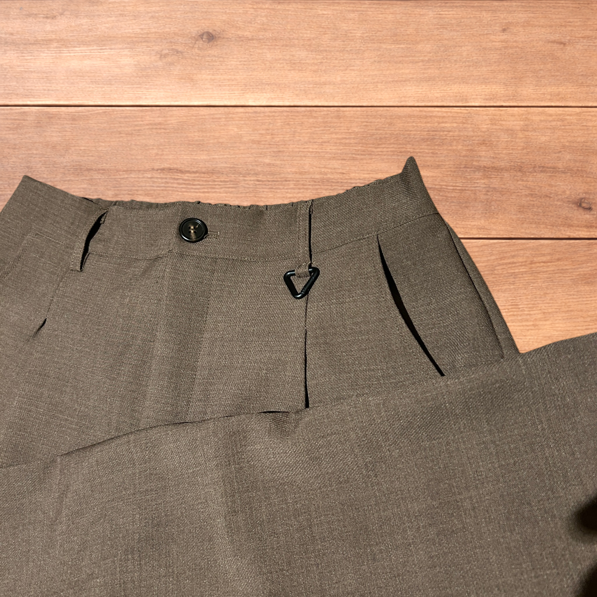 Vintage style baggy wide leg tailored brown trousers laid flat showing front, back, waistband, and clasp detail