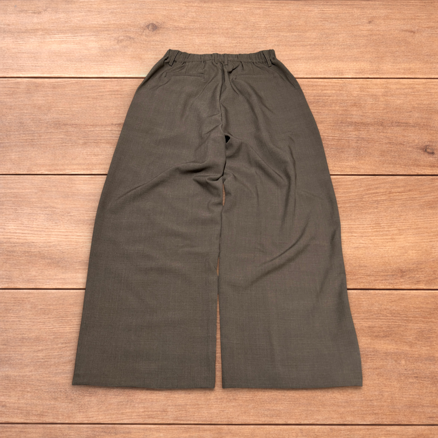 Vintage style baggy wide leg tailored brown trousers laid flat showing front, back, waistband, and clasp detail