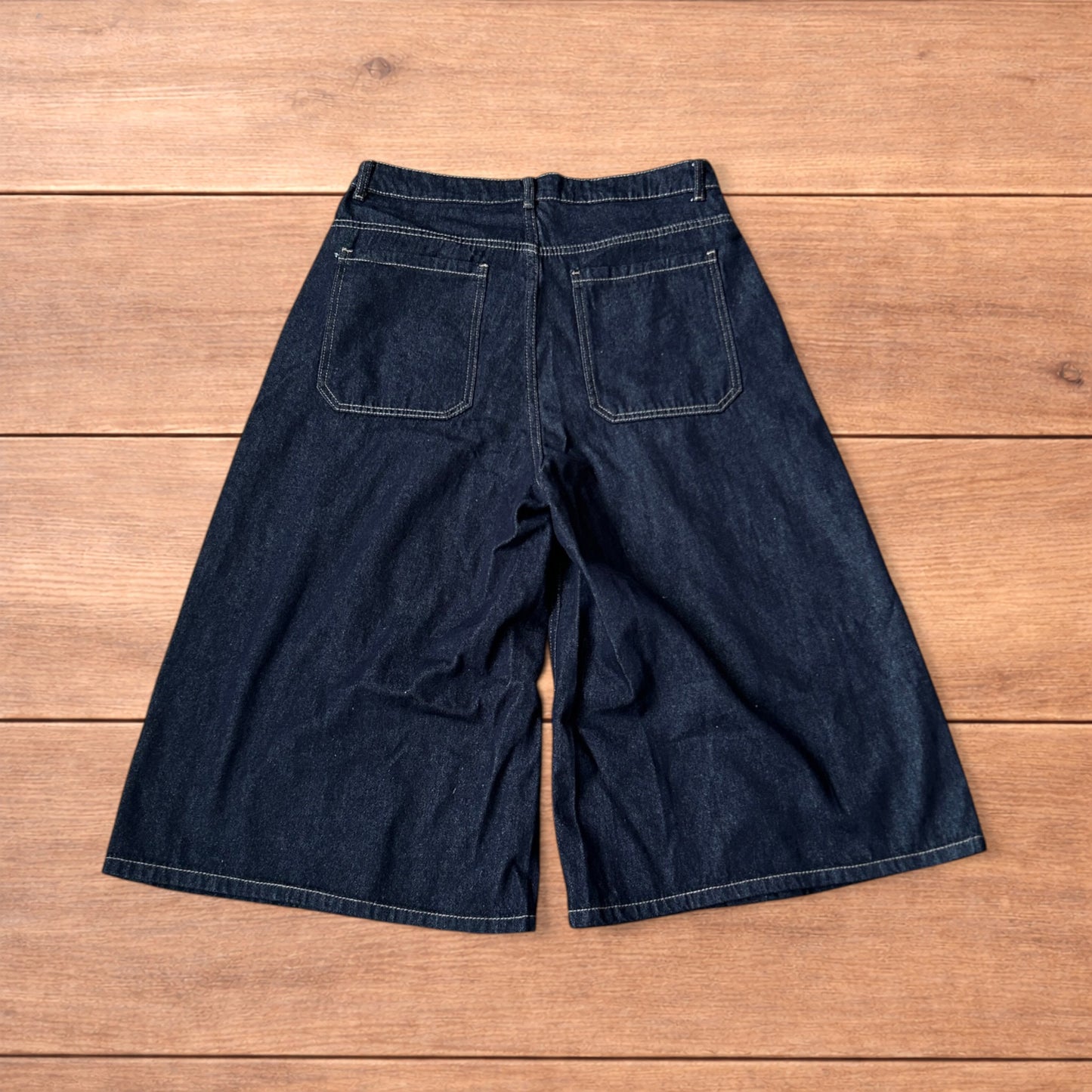 Super baggy wide leg raw denim style 3/4 shorts jorts in dark indigo blue.