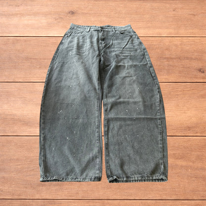 Vintage style baggy wide leg skater fit jeans in grey with paint splatters.