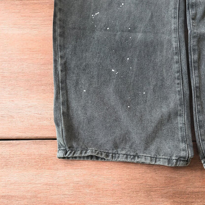 Vintage style baggy wide leg skater fit jeans in grey with paint splatters.