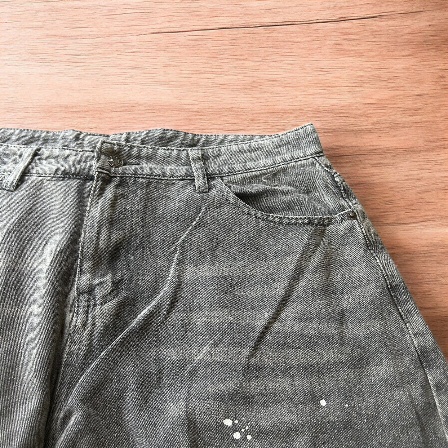Vintage style baggy wide leg skater fit jeans in grey with paint splatters.