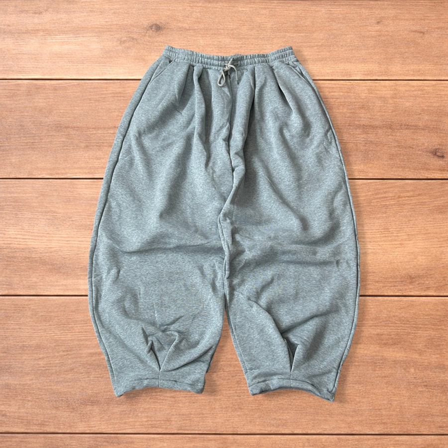 Super baggy wide leg Japanese joggers in marl grey laid flat on a wooden surface showing front, back, and close-up details.