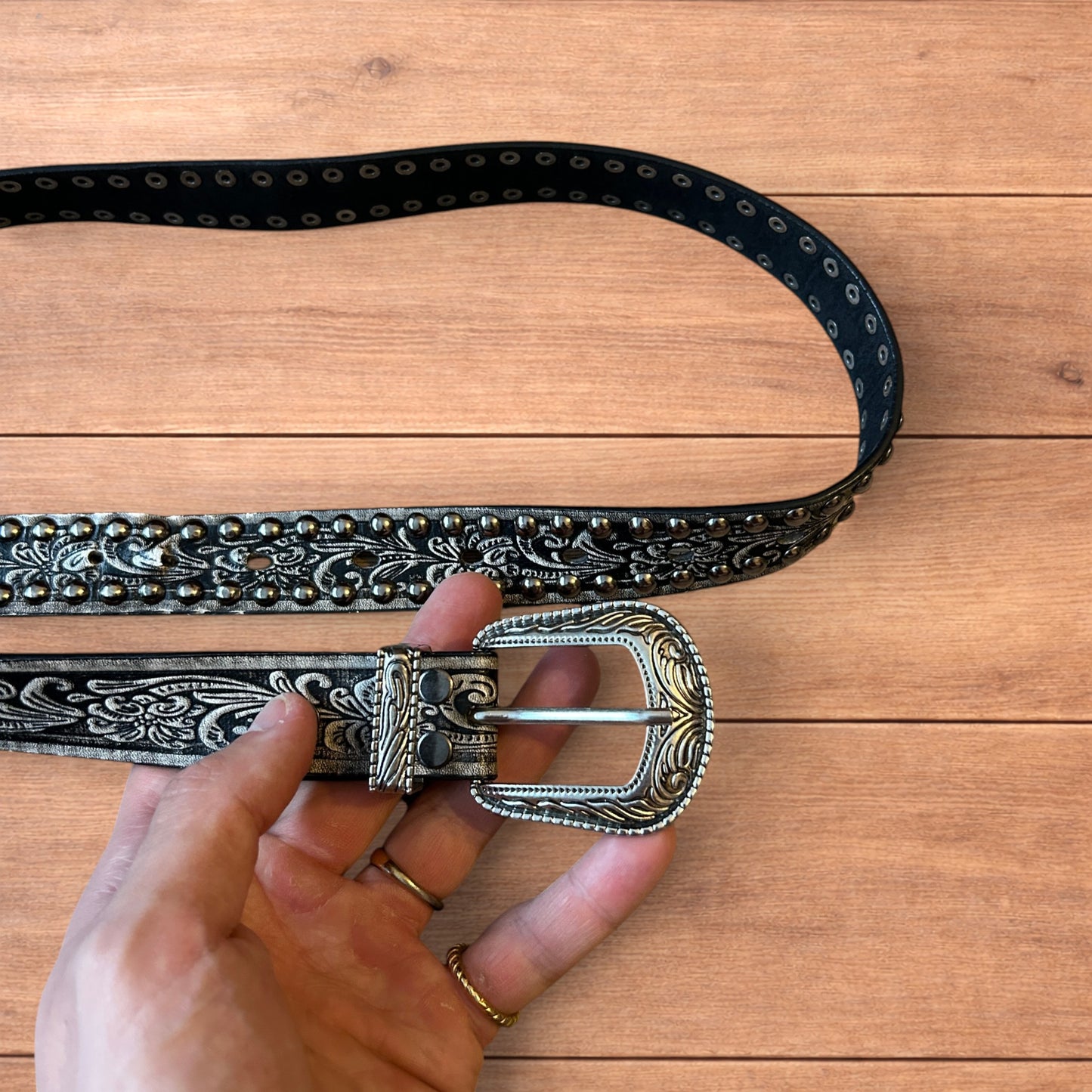 Vintage style faux leather western cowboy gothic belt in black with silver trim.