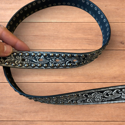 Vintage style faux leather western cowboy gothic belt in black with silver trim.
