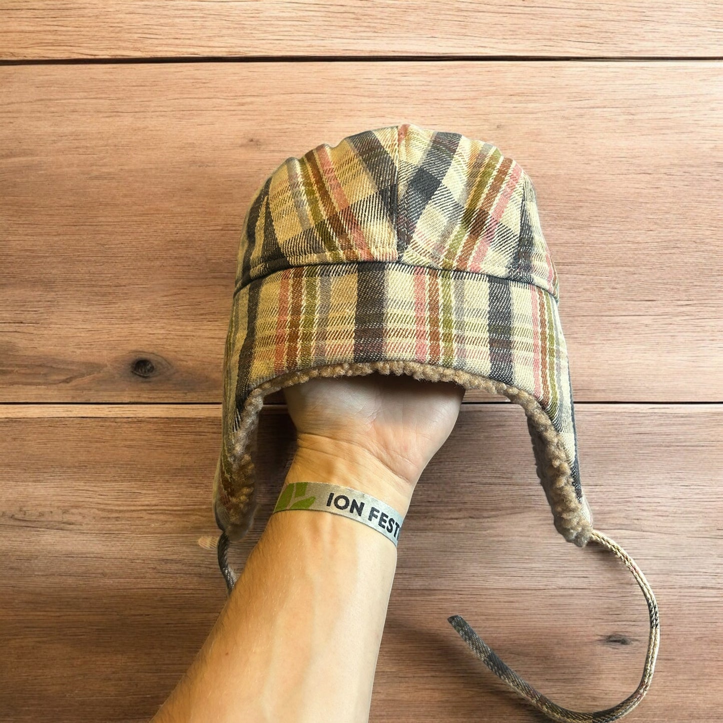 Trapper ear flap winter hat in checkered beige colour way. One size.