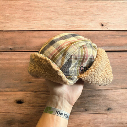 Trapper ear flap winter hat in checkered beige colour way. One size.