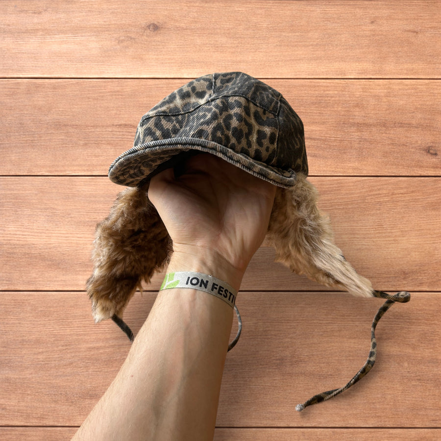 Vintage style trapper Russian ear flap hat cap in leopard and beige, shown from multiple angles with faux fur lining.