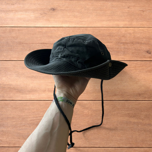 Vintage style denim fishermans boonie hat in washed black held against wooden background