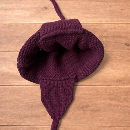 Vintage style dappy ear flap bobble hat in dark red.