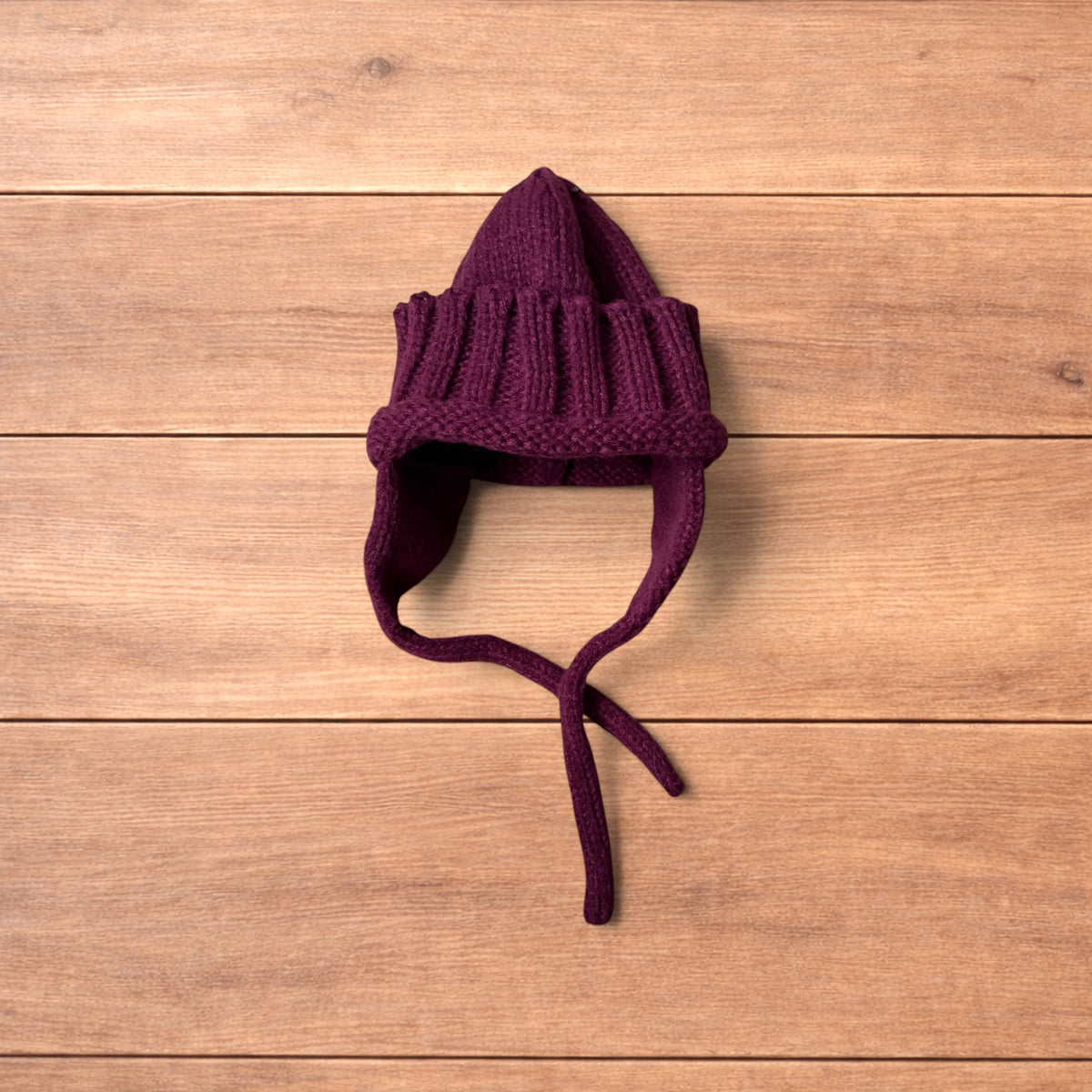 Vintage style dappy ear flap bobble hat in dark red.