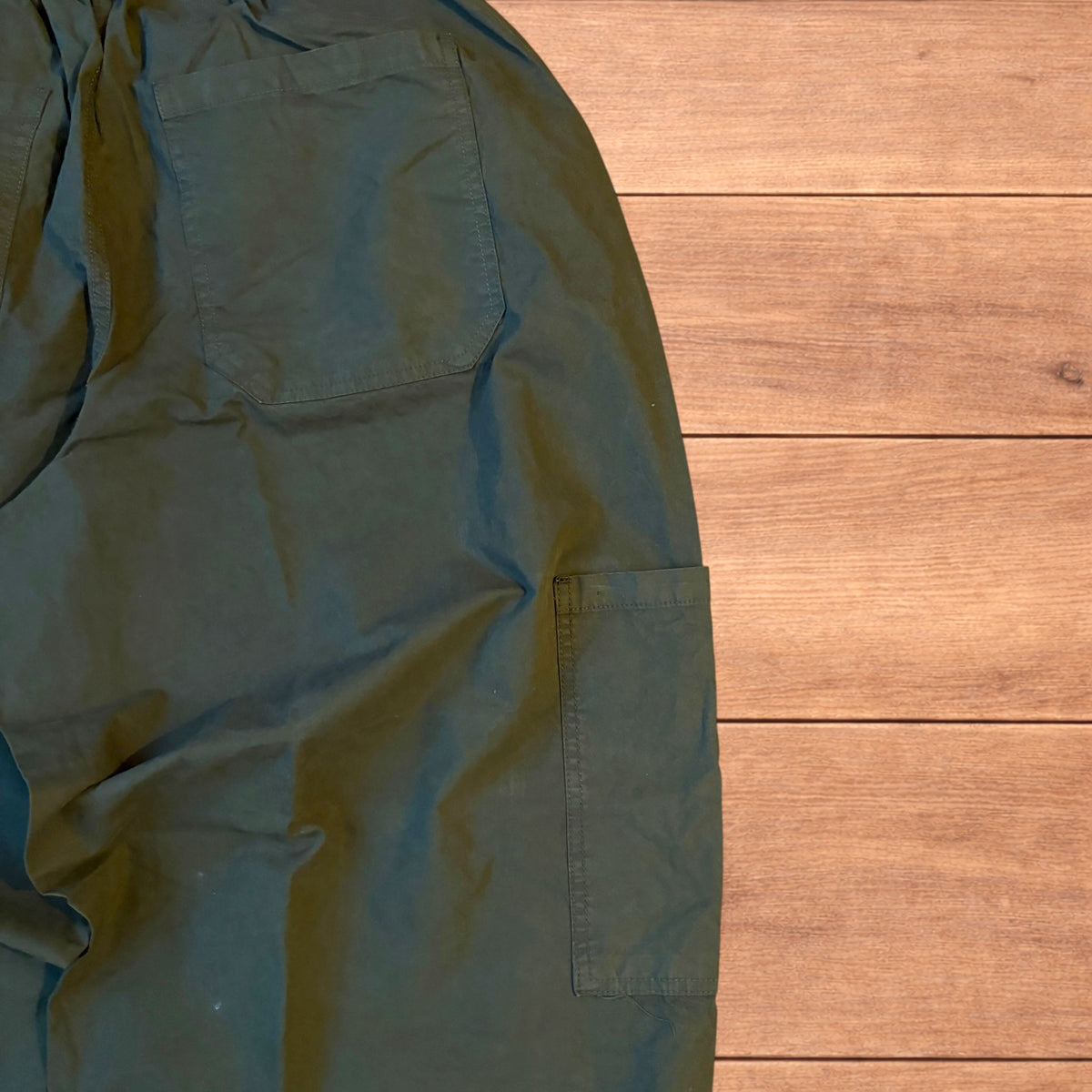 Baggy wide leg ripstop cargo trousers in khaki green with pockets, elasticated waist, and toggled hems.