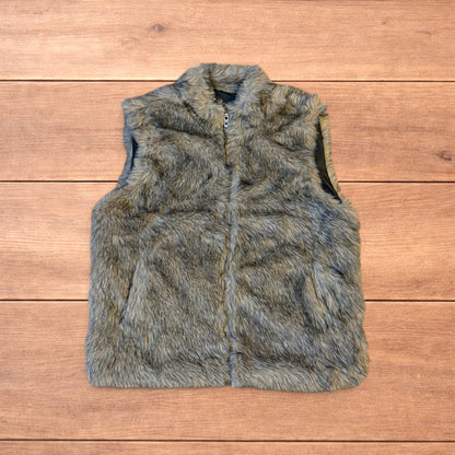 Beige brown faux fur gilet jacket with full zip on wooden surface