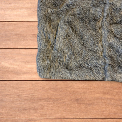 Beige brown faux fur gilet jacket with full zip on wooden surface
