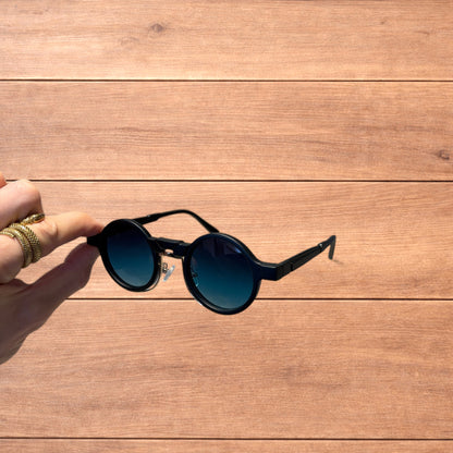 Vintage steampunk style rounded sunglasses in black with green gradient lense.