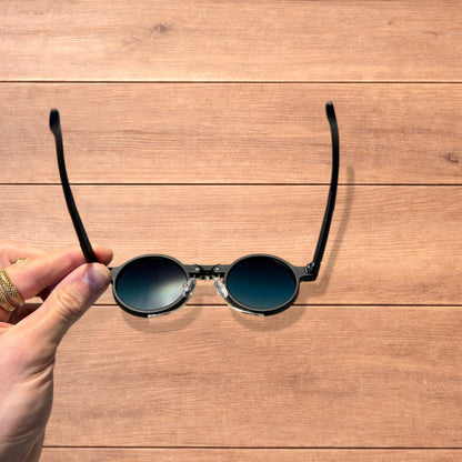 Vintage steampunk style rounded sunglasses in black with green gradient lense.