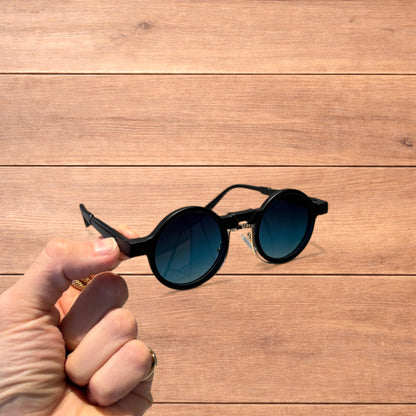 Vintage steampunk style rounded sunglasses in black with green gradient lense.