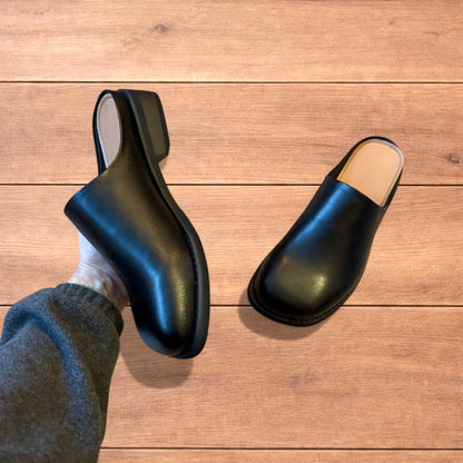 Lovely faux leather slip on clogs slippers in black.