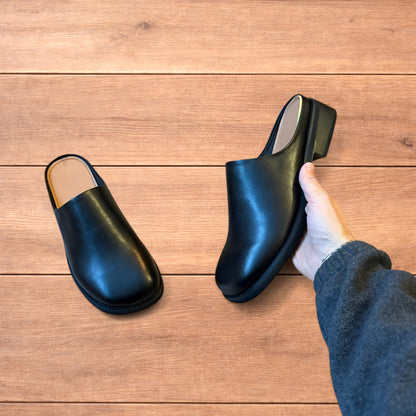 Lovely faux leather slip on clogs slippers in black.