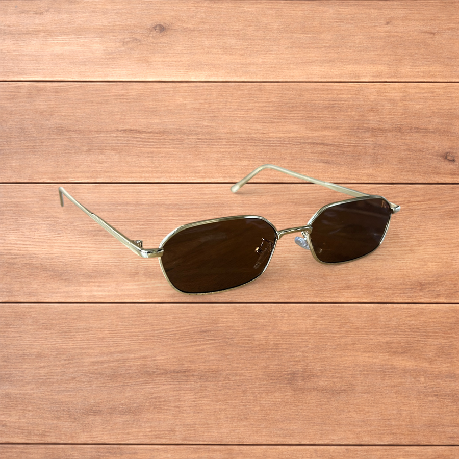 Gold framed sunglasses with brown polarised lenses on wooden surface