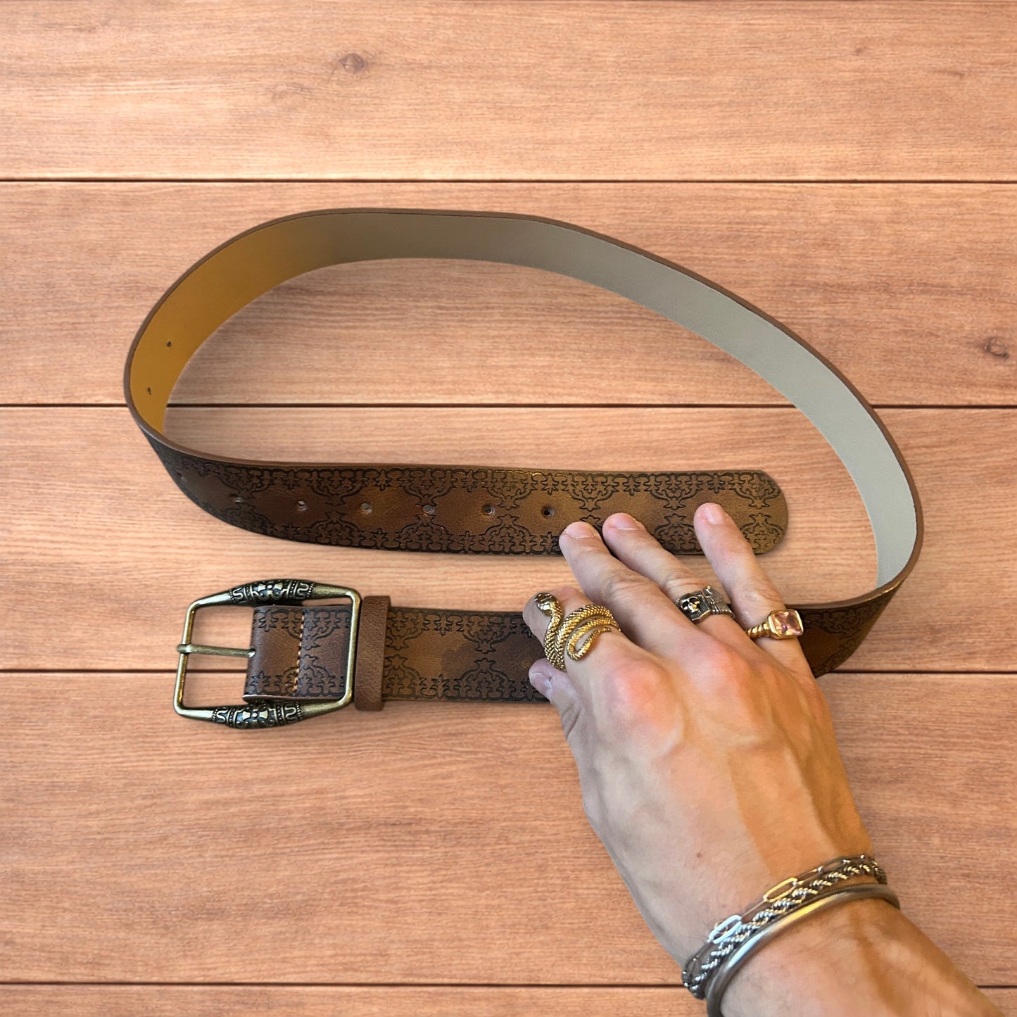 Vintage style faux leather western cowboy belt in brown with bronze trim.